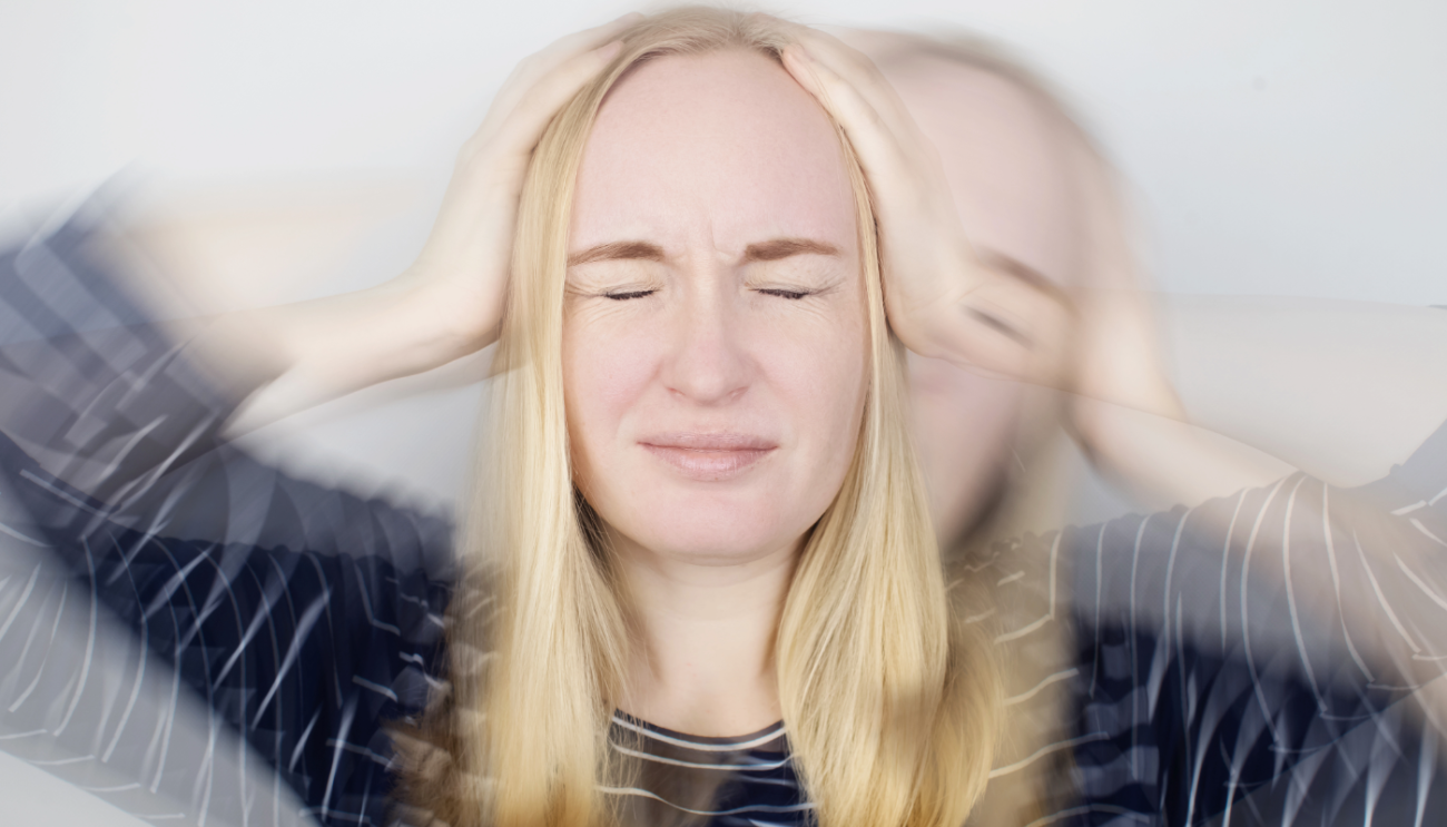 Girl holding her head with a blurred image indicating dizziness as a symptom of Neurological condition in Naples, FL