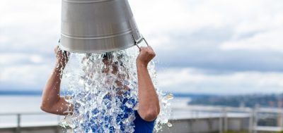 Child Pouring a Bucket of Water on Their Head